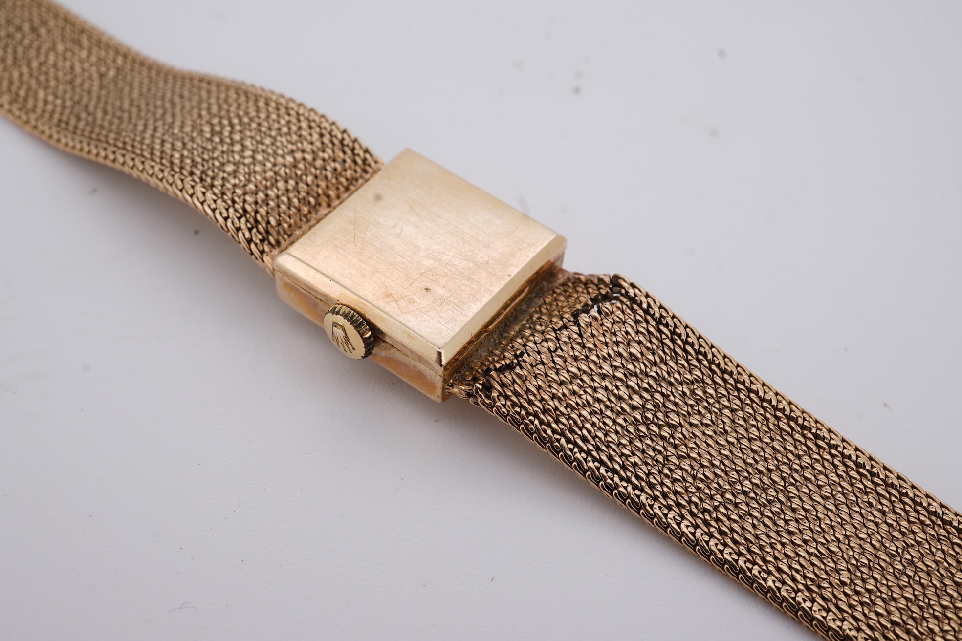 A lady's 1960's 9ct gold Rolex Precision manual wind wrist watch, with square dial, on an integral 9ct gold bracelet, the clasp with Rolex crown, overall length 15cm, gross weight 22 grams (bracelet a.f.)